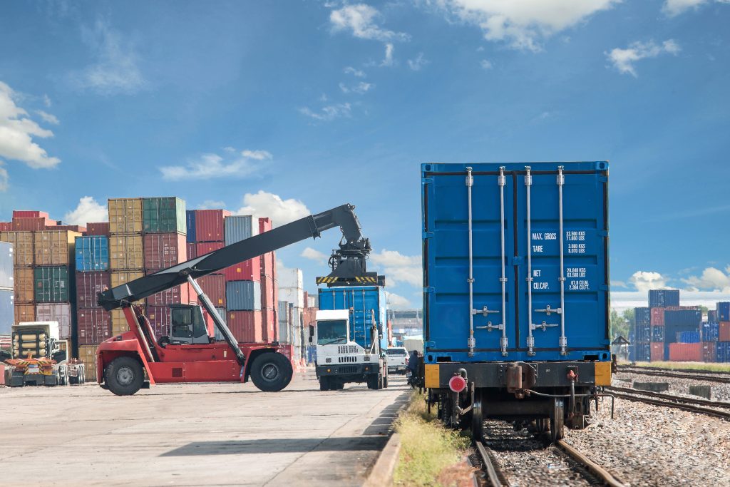 forklift handling container box loading to freight train
